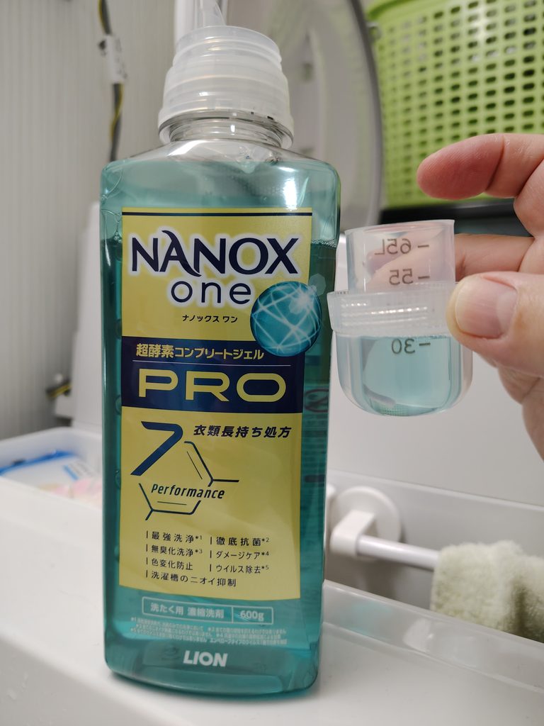 洗剤を入れすぎないように、計量キャップで確認しているところ