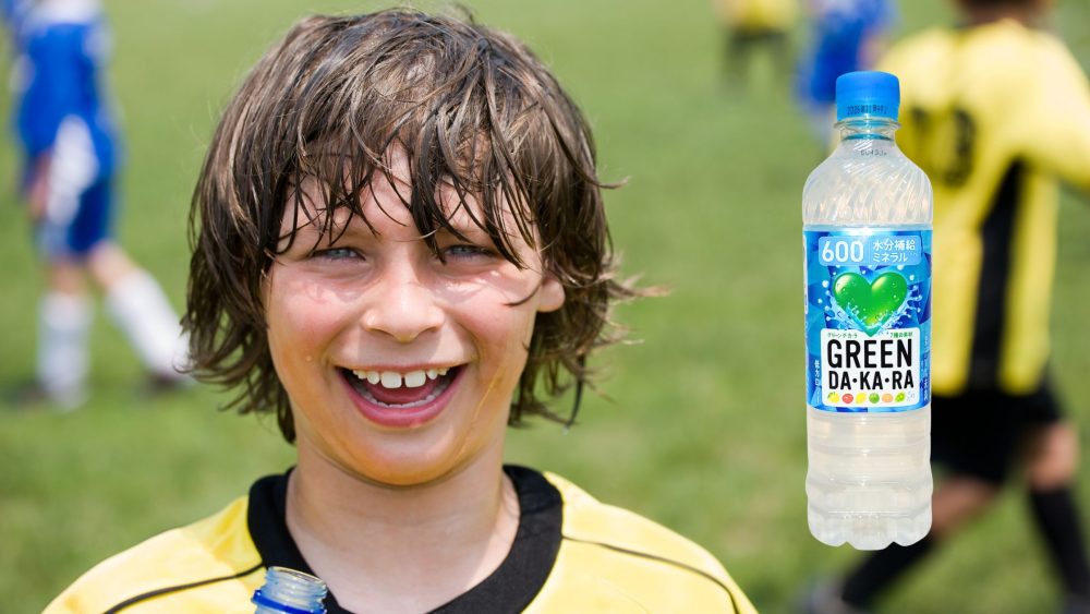 運動後にグリーンダカラを飲む少年の写真